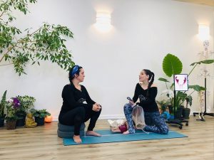 Jennifer More is holding a model of a placenta and teaching her student how the placenta and umbilical cord function.
